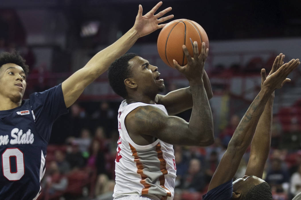 UNLV Rebels guard Amauri Hardy (3) drives past Jackson State Tigers guard Venjie Wallis (0) and ...