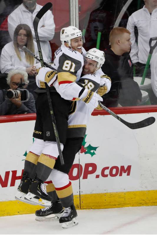 Vegas Golden Knights right wing Reilly Smith (19) lifts center Jonathan Marchessault (81) in th ...