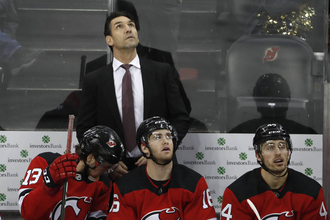 New Jersey Devils interim coach Alain Nasreddine watches a video replay of the third goal score ...