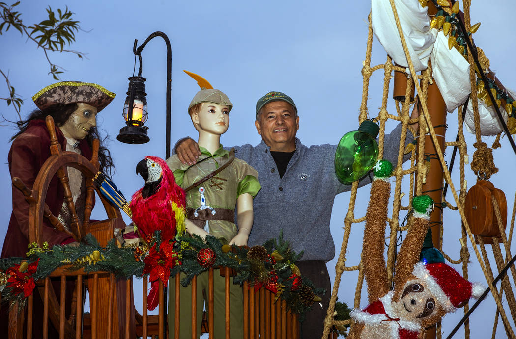 Juan Torres stands atop the pirate ship he built for his wife, Maria, as part of a holiday ligh ...