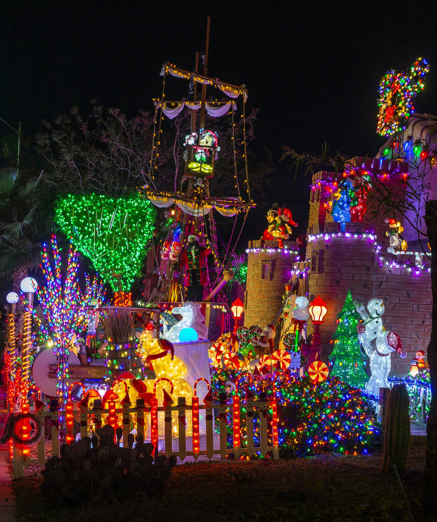 A pirate ship and castle anchor the holiday lights display in the yard of Maria and Juan Torres ...