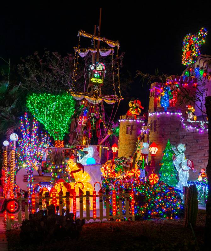 A pirate ship and castle anchor the holiday lights display in the yard of Maria and Juan Torres ...