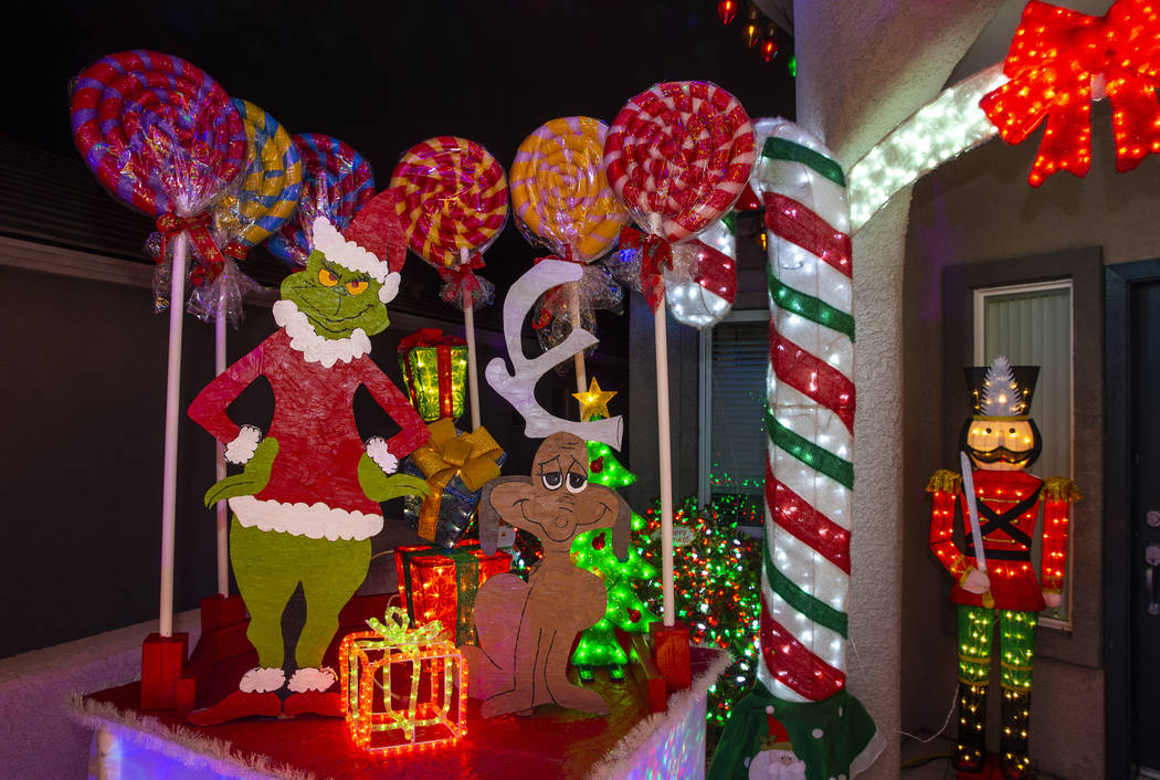 The Grinch Who Stole Christmas is part of the holiday lights display in the yard of Maria and J ...