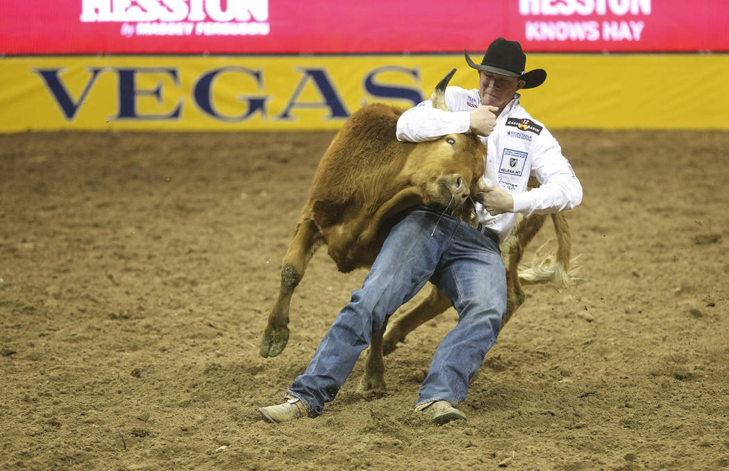 Ty Erickson of Helena, Mont. (59) competes in the steer wrestling event during the ninth go-rou ...