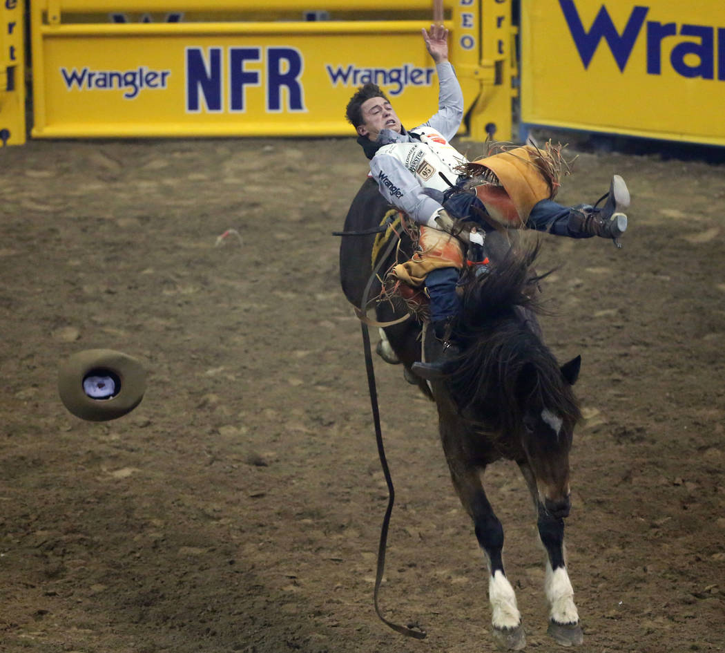 Clayton Biglow of Clements, Calif. (10) rides "Top Flight" while competing in barebac ...