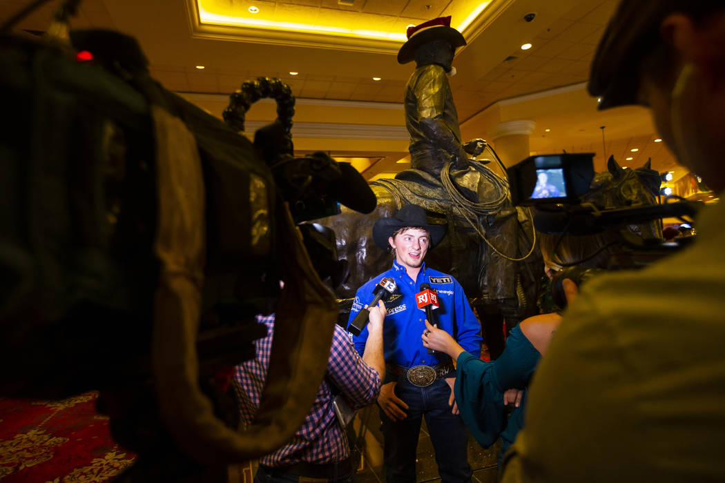 National Finals Rodeo contestant Rusty Wright, of Milford, Utah, is interviewed after walking o ...