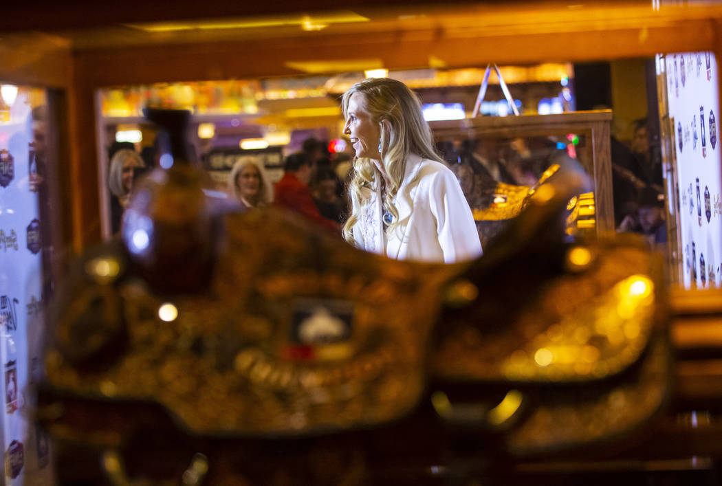 National Finals Rodeo contestant Cheyenne Wimberley, of Stephenville, Texas, walks on the gold ...