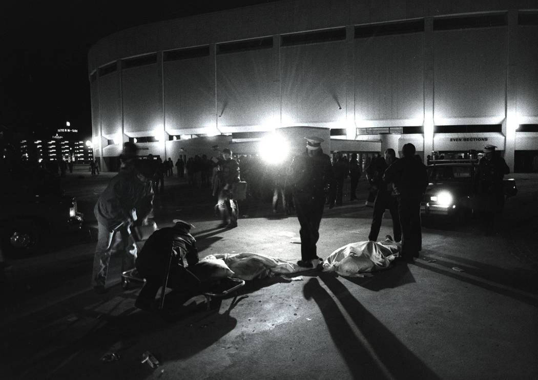 FILE - In this Dec. 3, 1979 file photo, Cincinnati police officers help people crushed during a ...