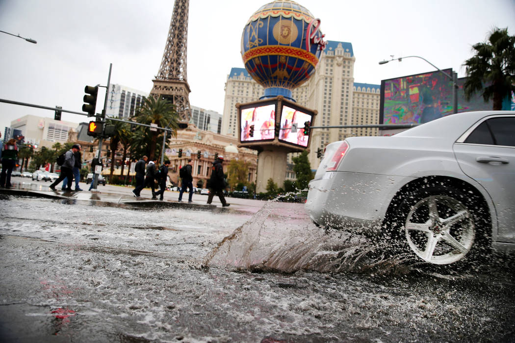 A flooded intersection across from the Planet Hollywood casino-hotel in Las Vegas as rains fall ...