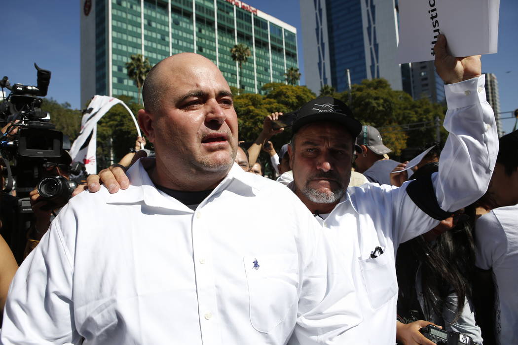 Julian LeBaron, left, walks with Adrian LeBaron before a protest against the first year in offi ...