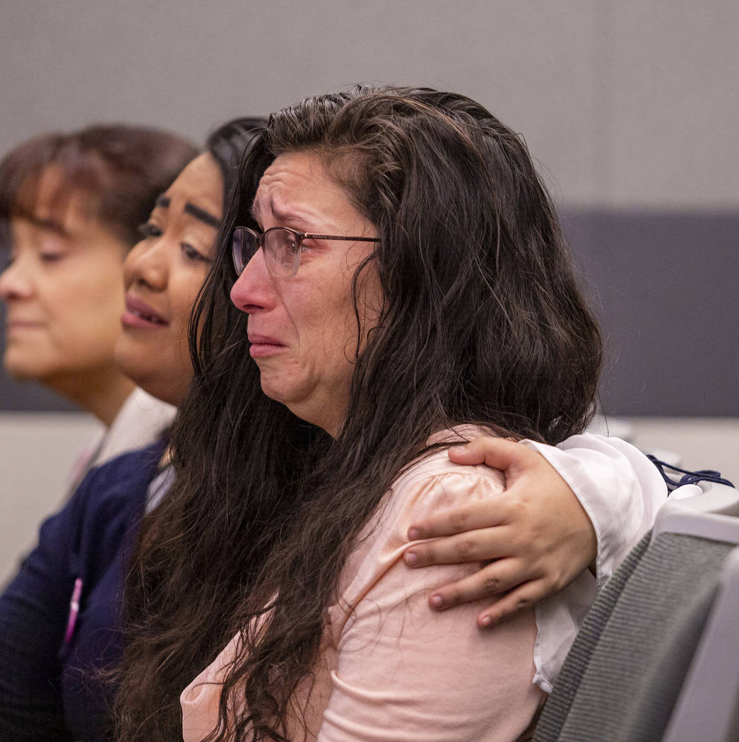 Amelia Claypool's stepmother, Shannon Harbour, is consoled by Claypool's friend Peanut Dela Cru ...