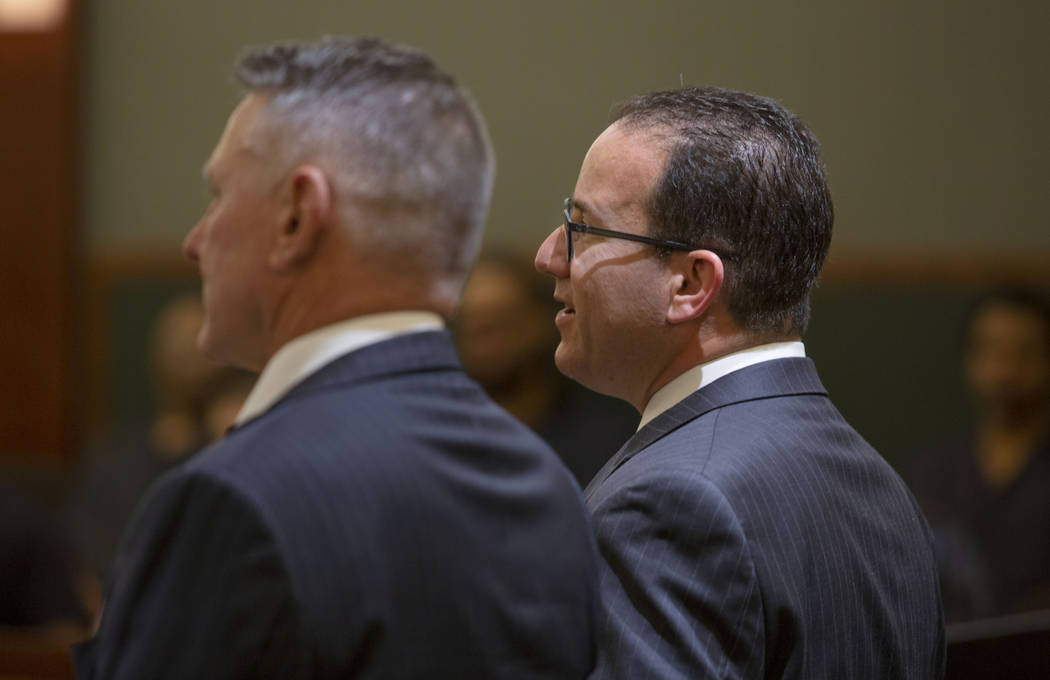 Gregory "Brent" Dennis, left, and defense attorney Richard Schonfeld speak to District Judge Mi ...