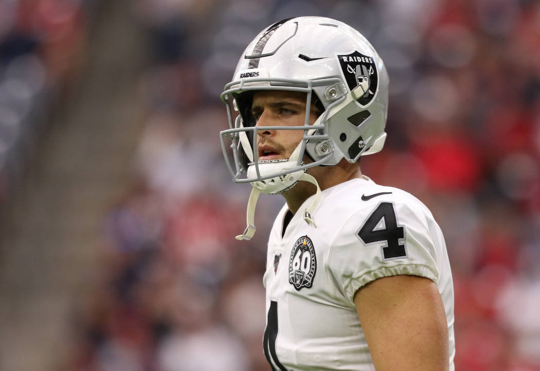 Oakland Raiders quarterback Derek Carr (4) walks on the field during the first half of an NFL g ...