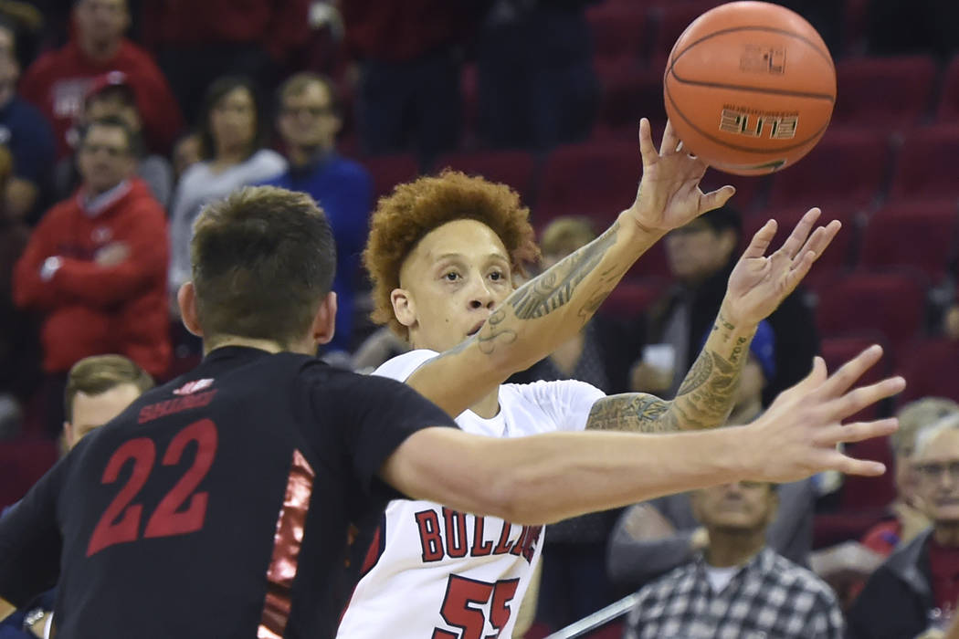 Fresno State's Noah Blackwell, right, passes the ball with UNLV's Vitaliy Shibel, left, defendi ...