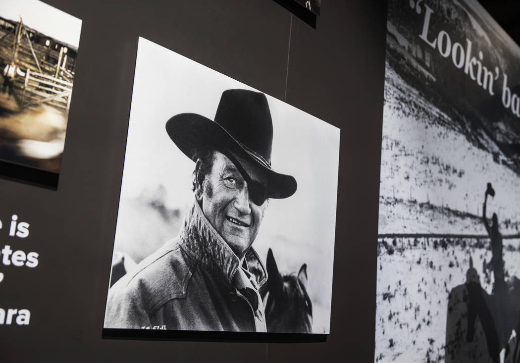 Photographs of movie icon John Wayne line the walls of the "John Wayne: Spirit of the West ...