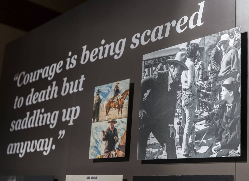 Photographs of movie icon John Wayne line the walls of the "John Wayne: Spirit of the West ...