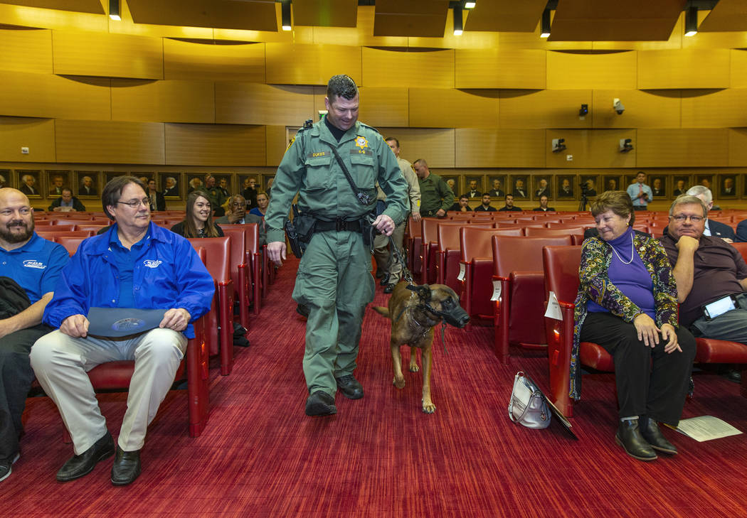 Las Vegas police K-9 officer Jason Dukes brings Hunter down to aisle to be recognized by the La ...