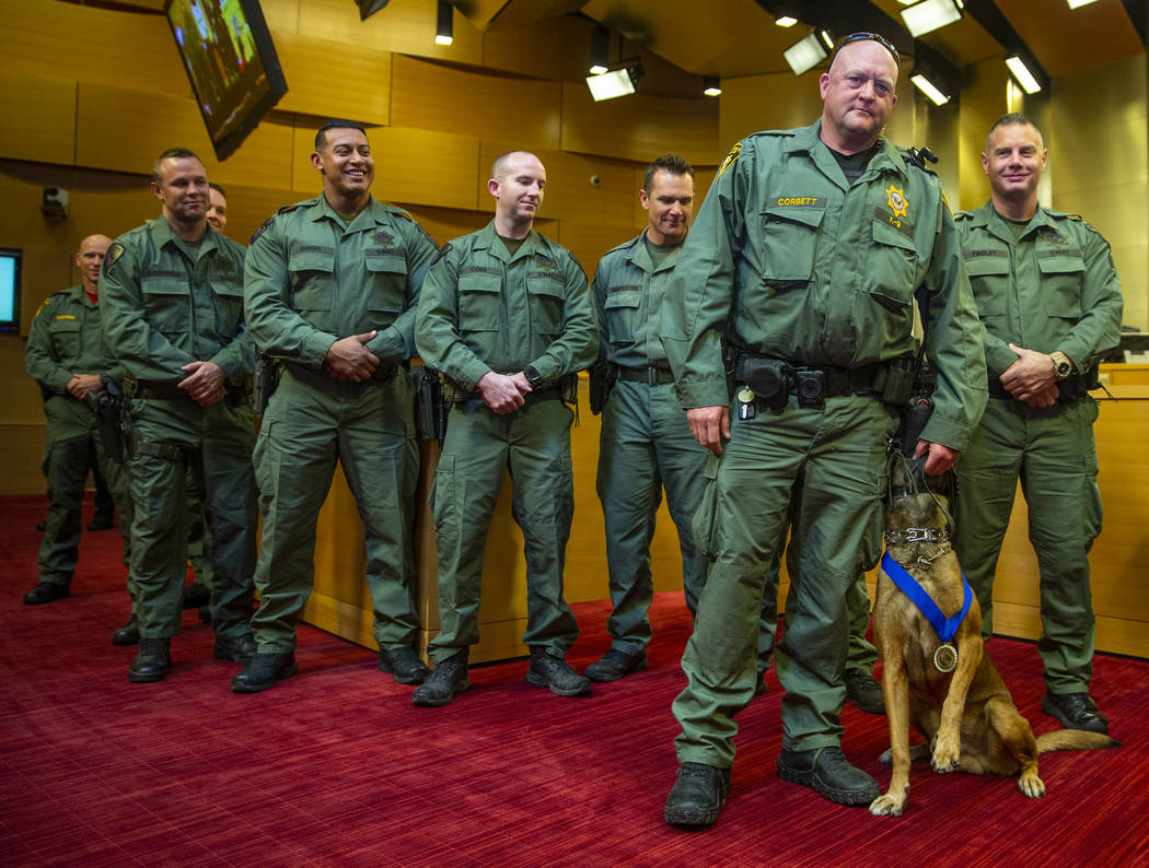Las Vegas police K-9 officer Jeff Corbett with his dog Hunter are flanked by other officers whi ...