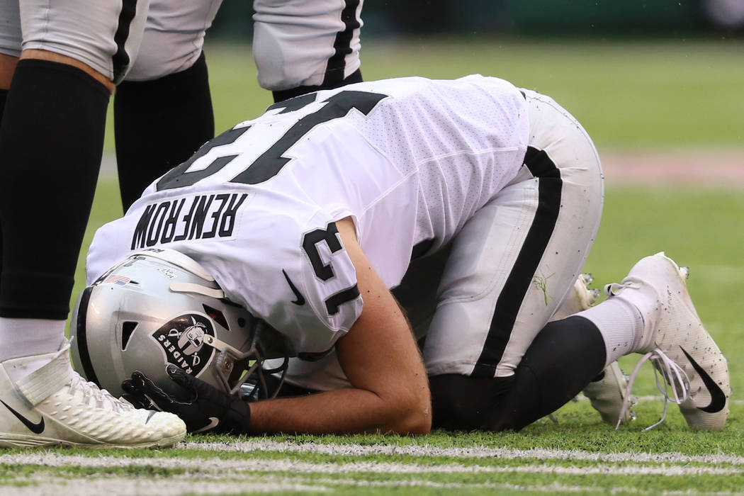 Oakland Raiders wide receiver Hunter Renfrow (13) remains on the field after being hit by New Y ...