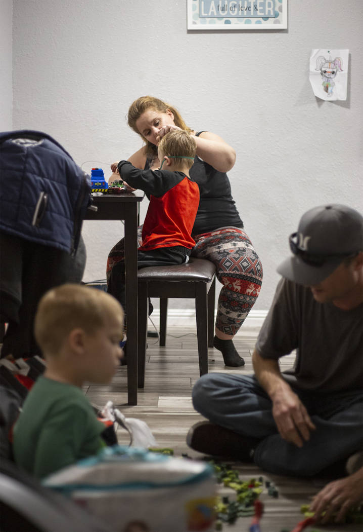 Joan Williams comforts her son, John Huebner, 2, while receiving his lung treatment, as his bro ...