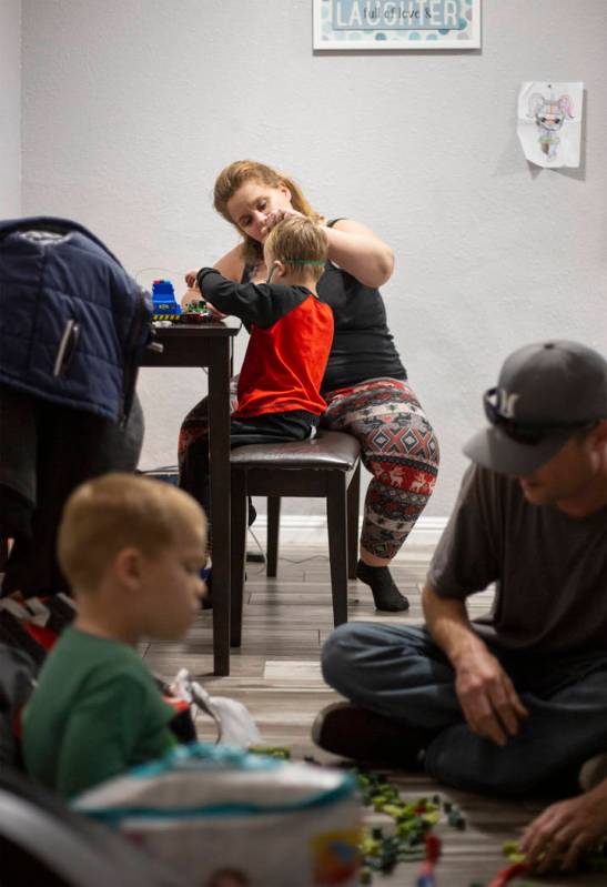 Joan Williams comforts her son, John Huebner, 2, while receiving his lung treatment, as his bro ...