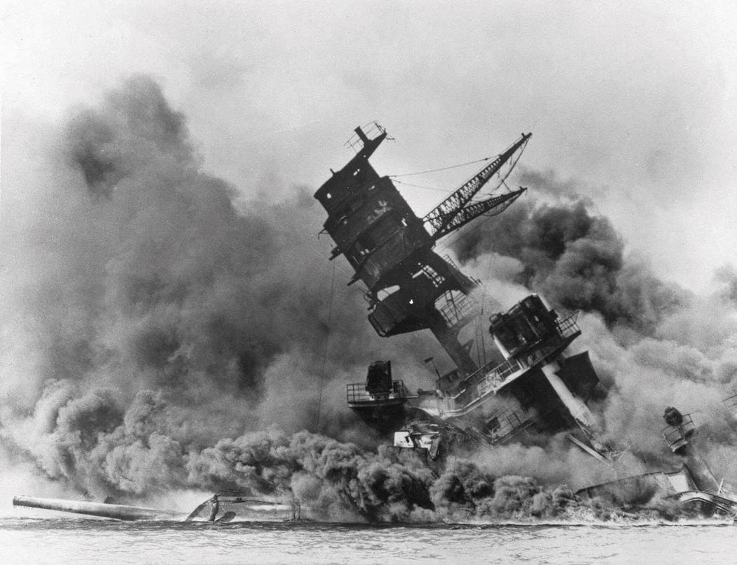 In this Dec. 7, 1941 file photo, smoke rises from the battleship USS Arizona as it sinks during ...