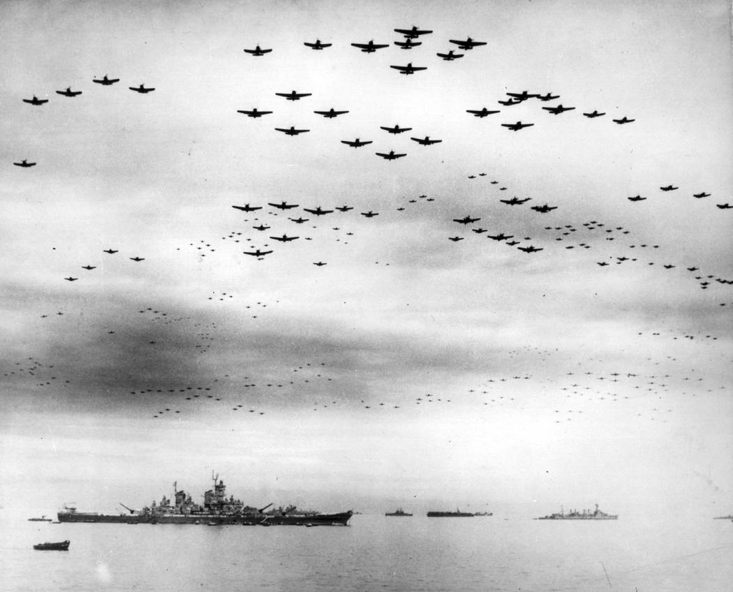In this Sept. 2, 1945 file image provided by the U.S. Navy, F4U and F6F fighter planes fly in f ...