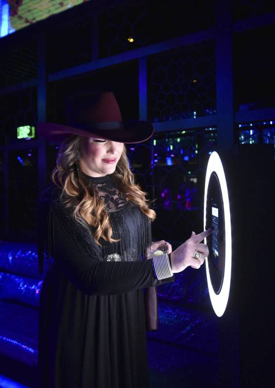 An attendee uses the selfie station during the WNFR Party With Abandon at the Ling Ling Club in ...