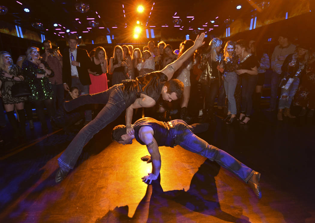 An acrobatic duo perform during the WNFR Party With Abandon at the Ling Ling Club in Hakkasan L ...