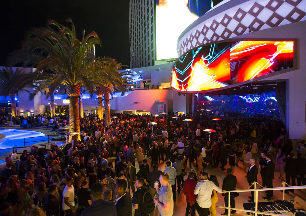 Attendees roam the outdoor area the during the grand opening weekend of Kaos, the dayclub and n ...