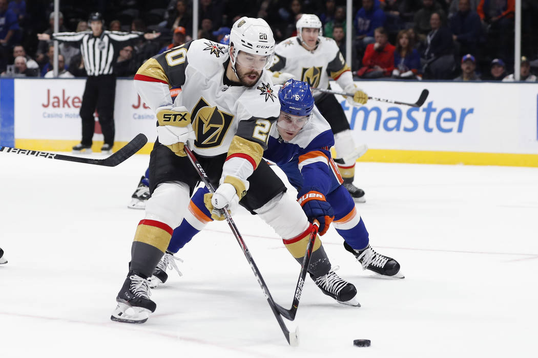 Vegas Golden Knights center Chandler Stephenson (20) tries to steer the puck away from New York ...