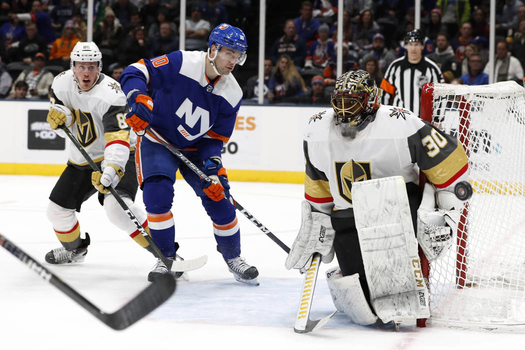 New York Islanders center Derick Brassard (10) watches as the puck glances off Vegas Golden Kni ...