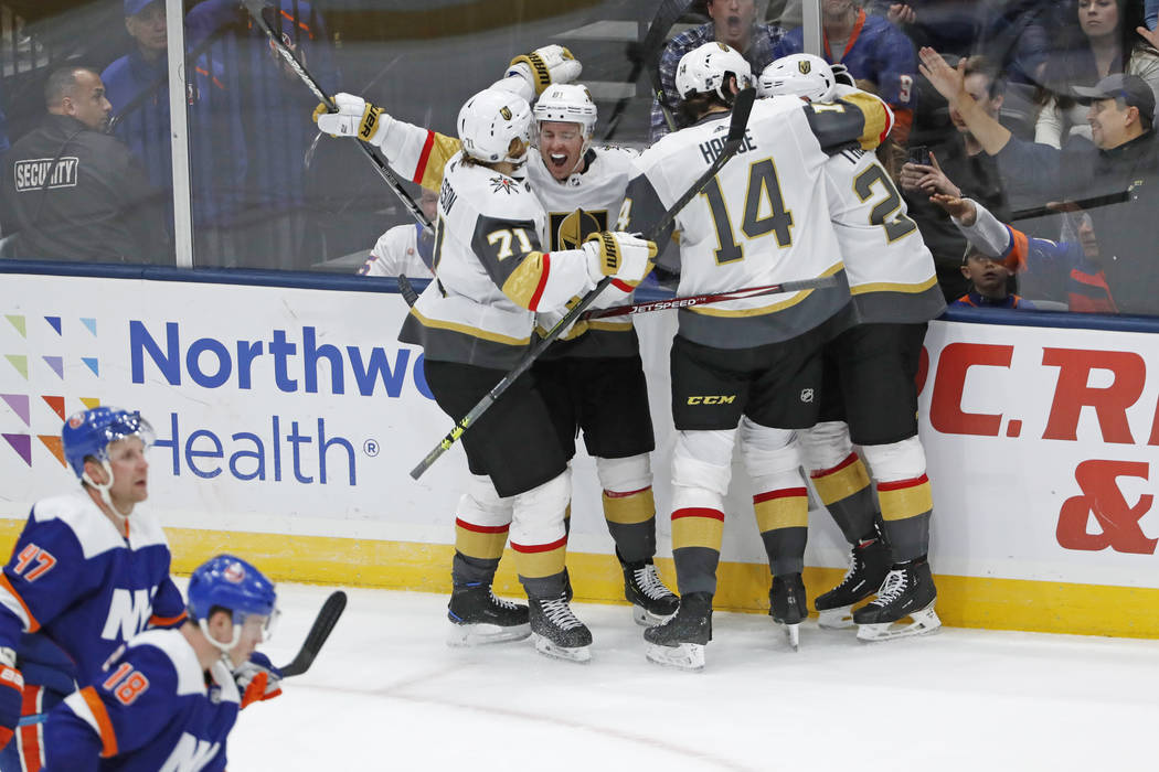 Vegas Golden Knights center Jonathan Marchessault (81) is congratulated by teammates after he s ...