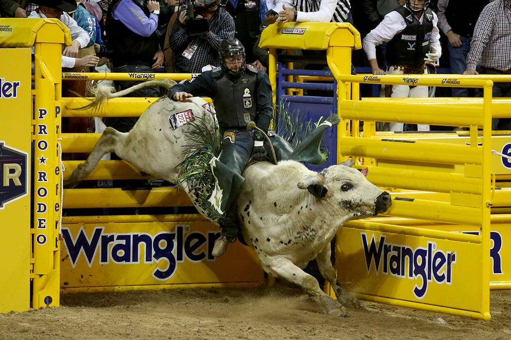 Jordan Hansen of Canada rides Hou's Bad News to a score of 89.5 in the Bull Riding competition ...