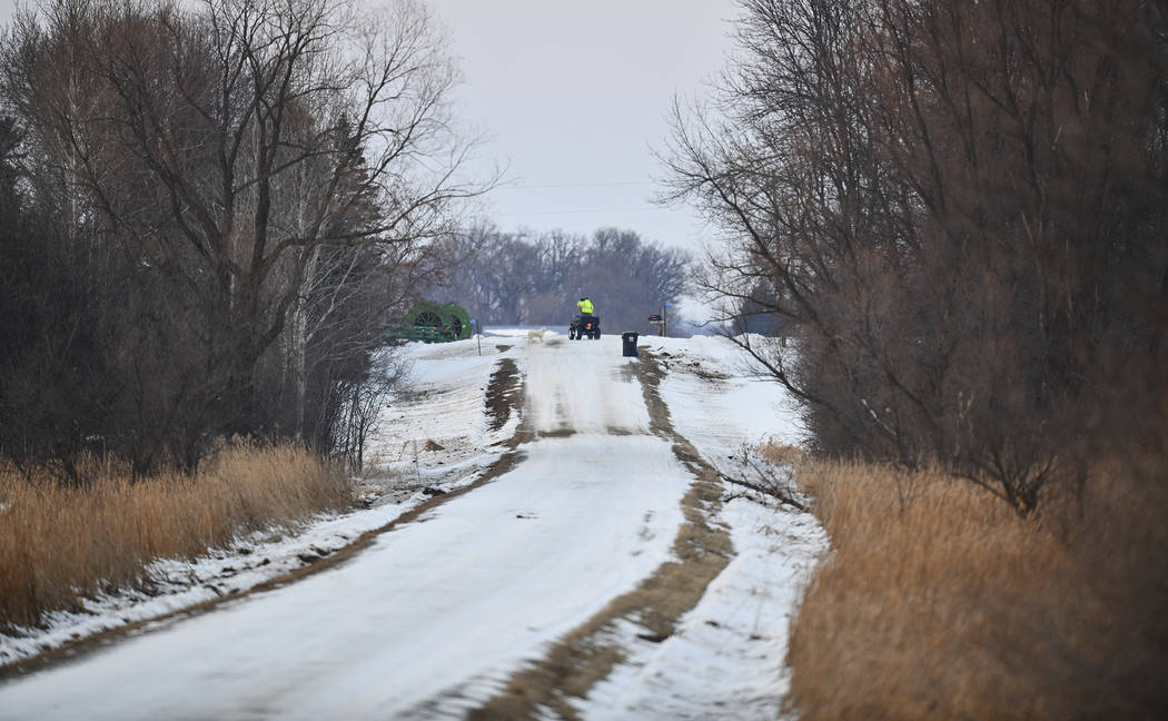 A rescue worker rides an ATV near the scene of a reported helicopter crash Thursday, Dec. 5, 20 ...