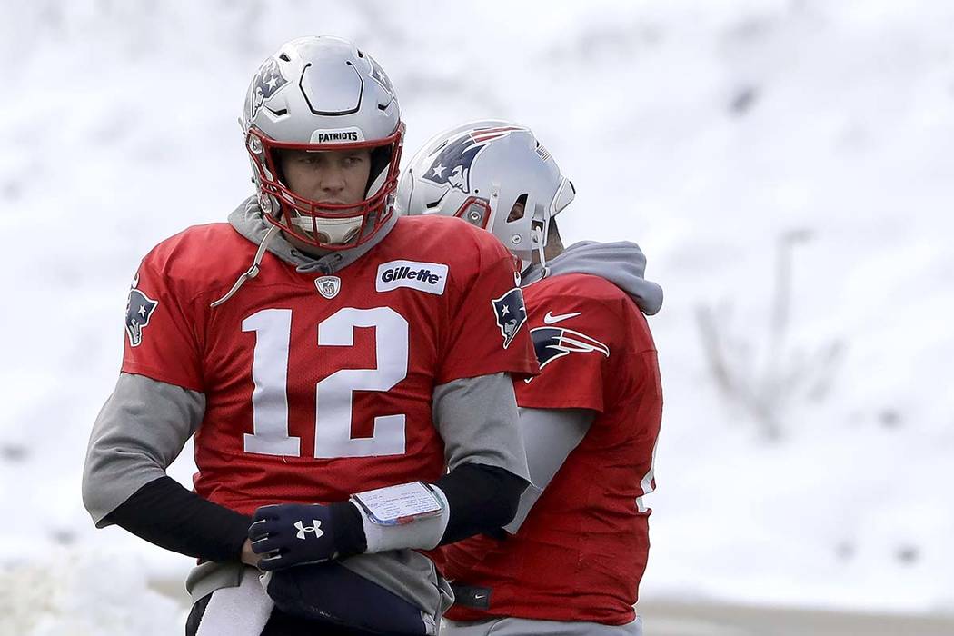 New England Patriots quarterback Tom Brady (12) warms up during an NFL football practice, Wedne ...