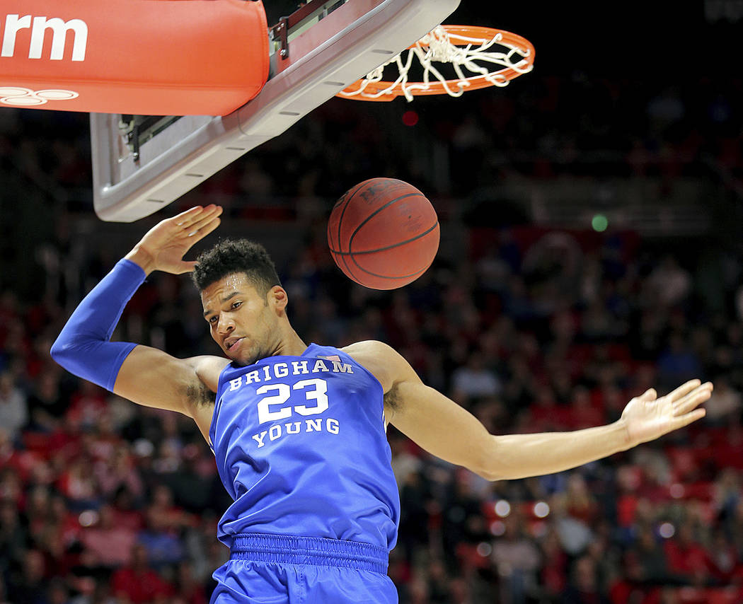 BYU forward Yoeli Childs (23) dunks against Utah during an NCAA college basketball game in Salt ...