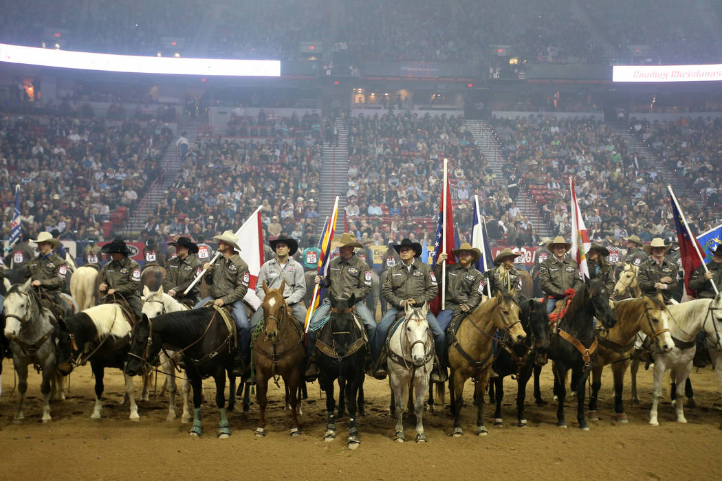 Competitors line up during the opening ceremony of the 10-day Wrangler National Finals Rodeo at ...