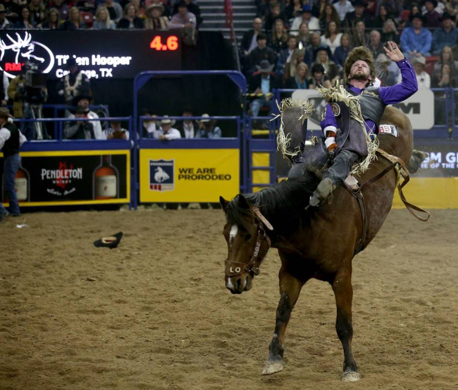 Tilden Hooper of Carthage, Texas rides Wilson Sanchez to a score of 88.5 in the Bareback Riding ...