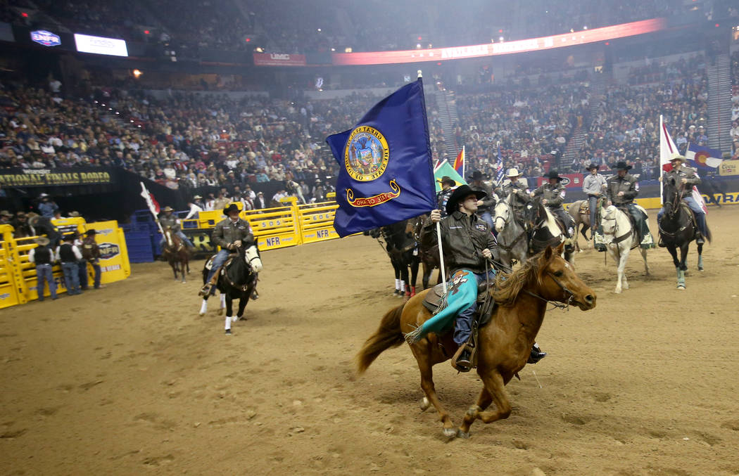 Garrett Smith of Rexburg, Idaho carries his state's flag during opening ceremony of the 10-day ...