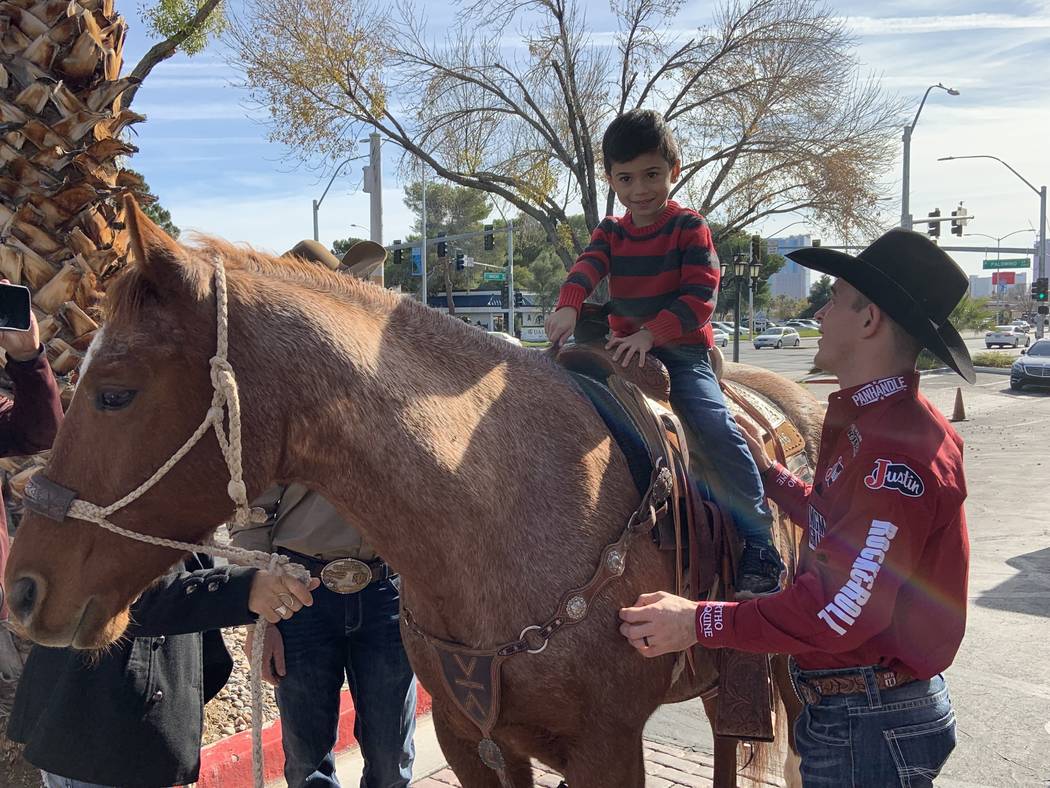 World champion bareback rider Tim O'Connell assists youngster Livan Chuffat in the saddle aboar ...