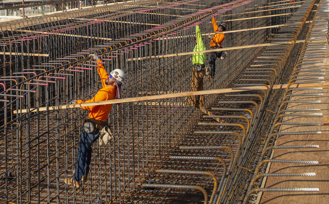 Construction workers install rebar on the Centennial Bridge connecting U.S. Highway 95 northbou ...