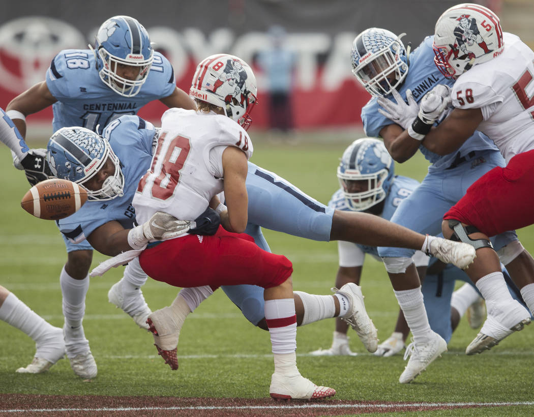 Centennial senior Thomas Lane (8) hits Liberty junior quarterback Daniel Britt (18) causing a f ...