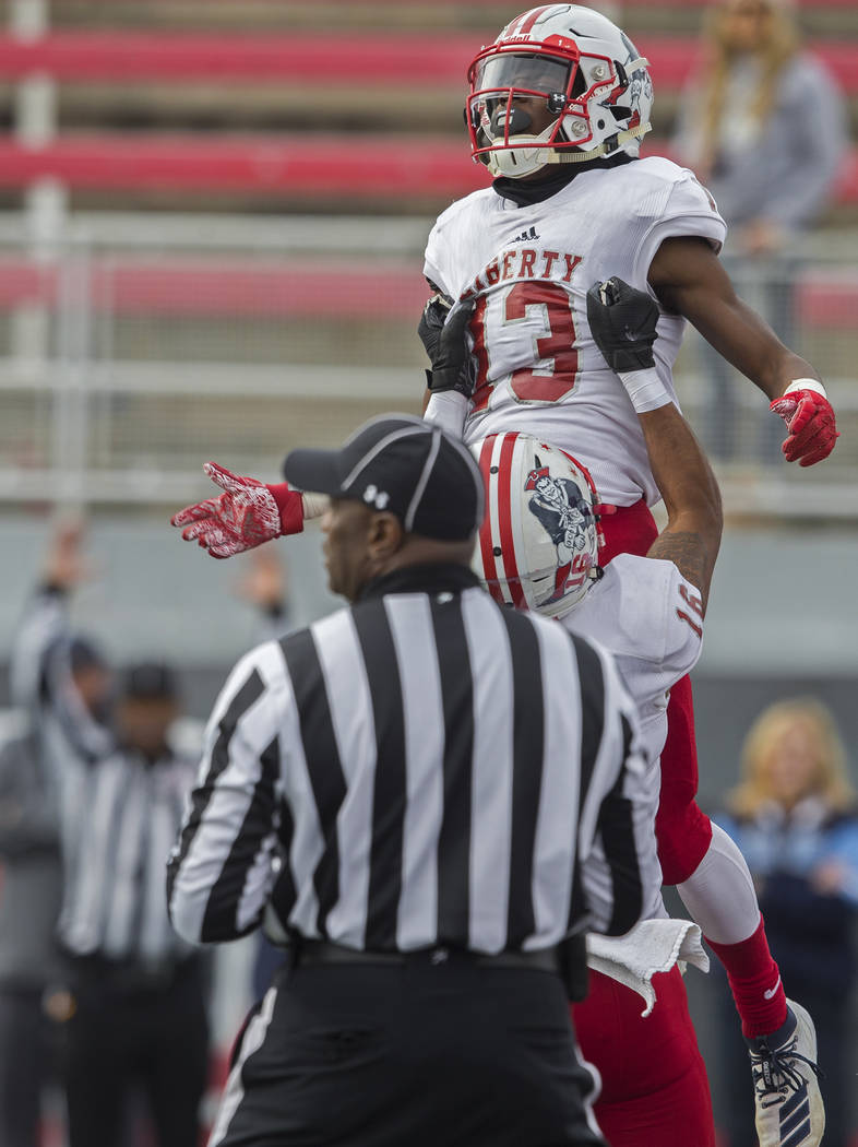 Liberty junior wide receiver Corey Hebert (13) celebrates with Liberty senior wide receiver Mau ...