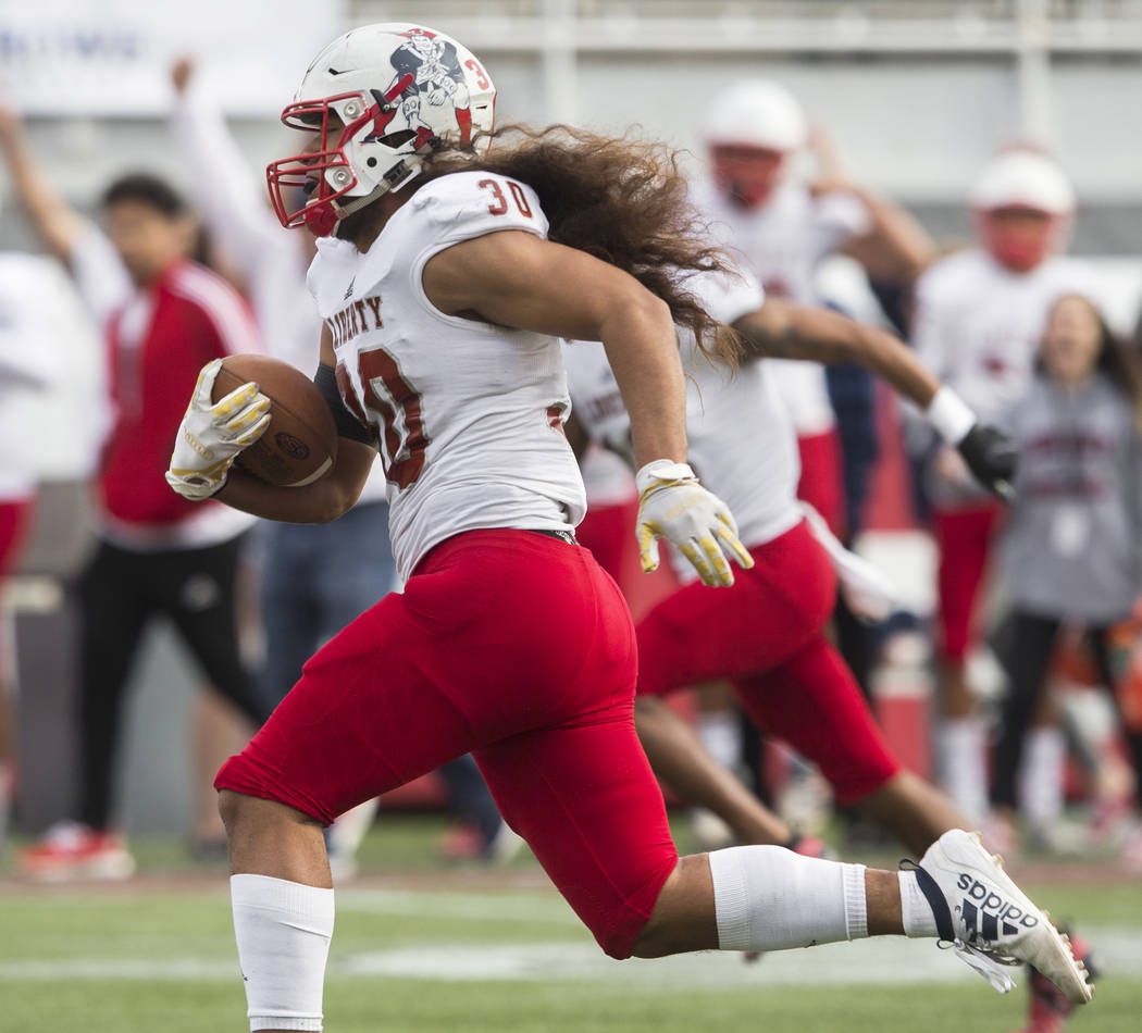 Liberty junior running back Zyrus Fiaseu (30) sprints up field for a first quarter touchdown du ...