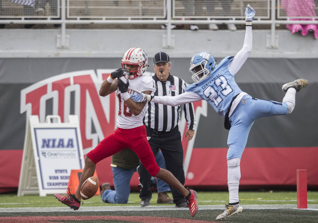 Centennial junior Jordan McGilbra (23) breaks up a pass to Liberty senior wide receiver Maurice ...