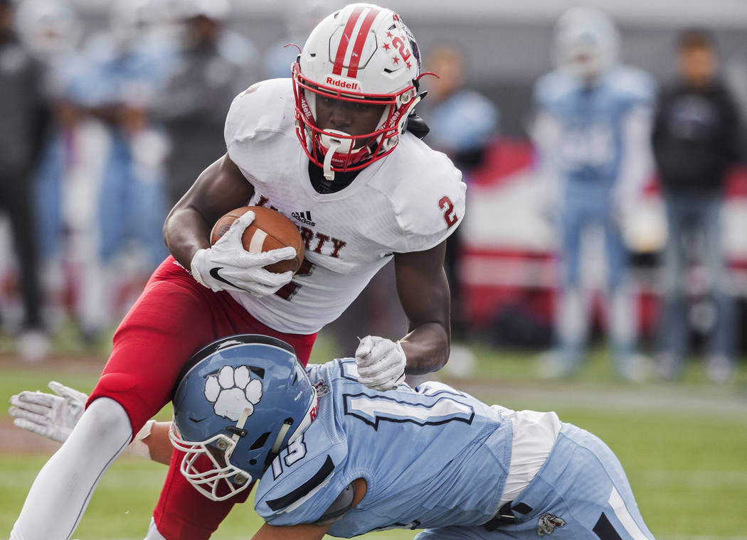 Liberty sophomore wide receiver Germie Bernard (2) drives towards the end zone over Centennial ...