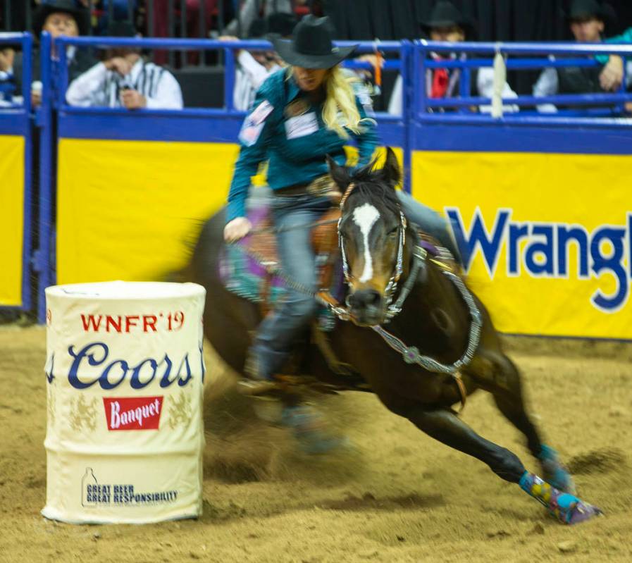 Amberleigh Moore of Salem, Oregon, navigates another barrel while taking first place in Barrel ...