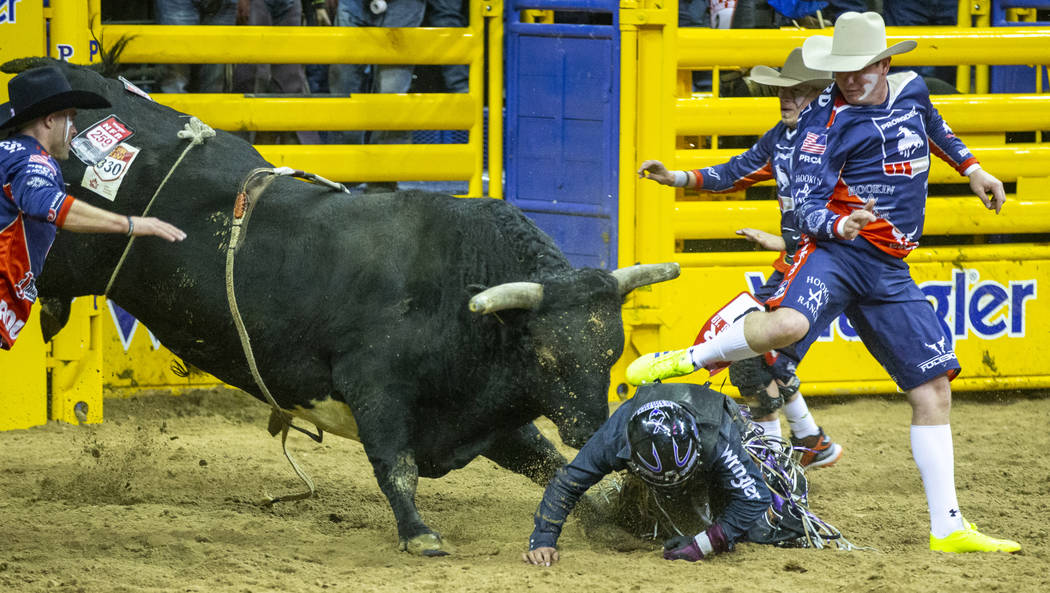 Daylon Swearingen of Rochelle, Georgia, is taken down by Hot And Ready as bullfighters attempt ...