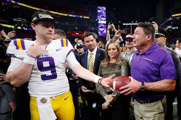 LSU quarterback Joe Burrow and LSU head coach Ed Orgeron celebrate after the Southeastern Confe ...